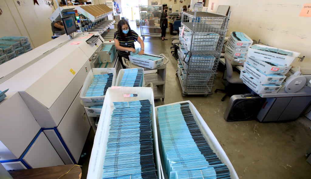 Ibon Suazo, a senior elections specialist with the county, prepares to feed mail in ballots into signature verification equipment, Wednesday, Nov. 4, 2020, at the Sonoma County Registrar of Voters. (Kent Porter / The Press Democrat) 2020