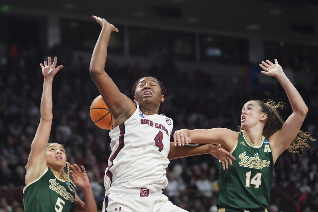 South Carolina forward Aliyah Boston (4) battles for the ball against South Florida guard Elena Tsineke (5) and Emma Johansson (14) during the first half in a second-round college basketball game in the NCAA Tournament, Sunday, March 19, 2023, in Columbia, S.C. (AP Photo/Sean Rayford)