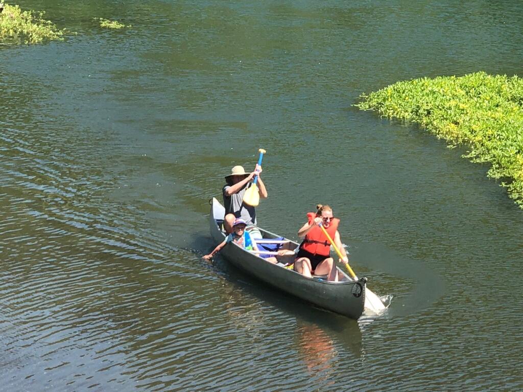 Canoers cool down during the heat wave on the Russian River. Recreational water users have been warned to watch out for algal blooms along local waterways. Roger Coryell photo.