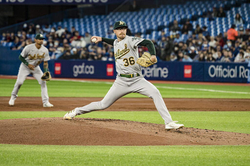 Oakland Athletics starting pitcher Adam Oller (36) throws the ball during the first inning of a MLB baseball game against the Toronto Blue Jays in Toronto on Sunday, April 17, 2022. (Christopher Katsarov/The Canadian Press via AP)