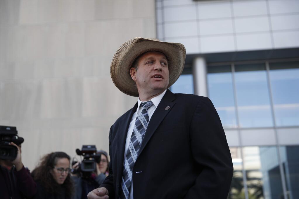 Ammon Bundy walks out of a federal courthouse in Las Vegas on Dec. 20 after Chief U.S. District Judge Gloria Navarro declared a mistrial in a case against Cliven Bundy, his sons Ryan and Ammon and self-styled Montana militia leader Ryan Payne. (JOHN LOCHER / Associated Press)