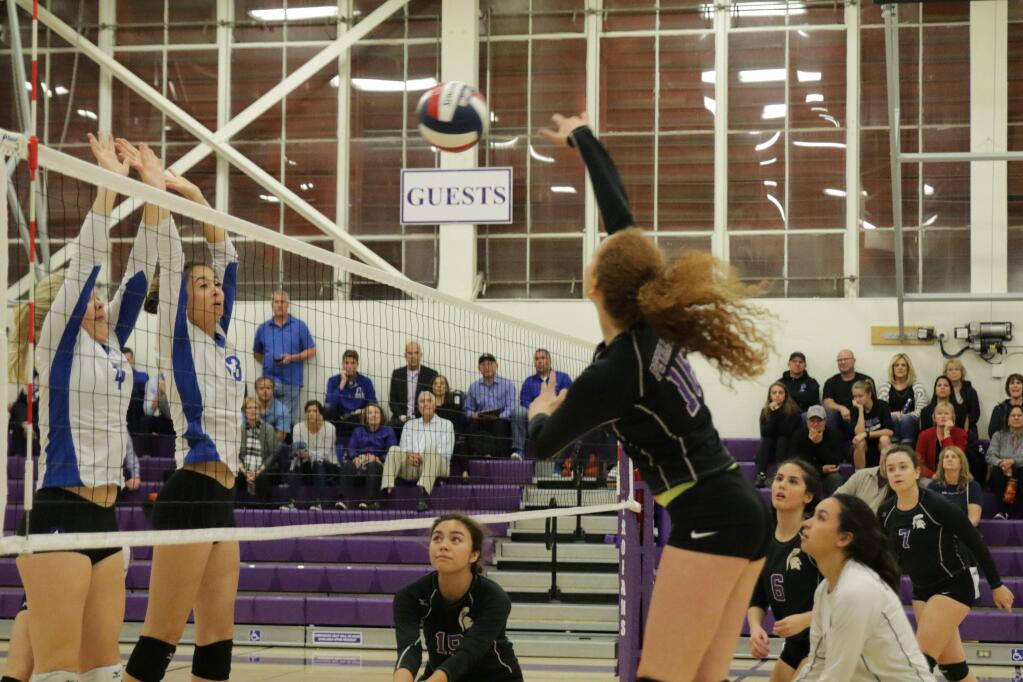 DWIGHT SUGIOKA FOR THE ARGUS-COURIERPetaluma's Hannah Dillingham slams the ball over a double block attempt by Acalanes' Lane Webster (4) and Zoe Mcphail in an NCS playoff match.