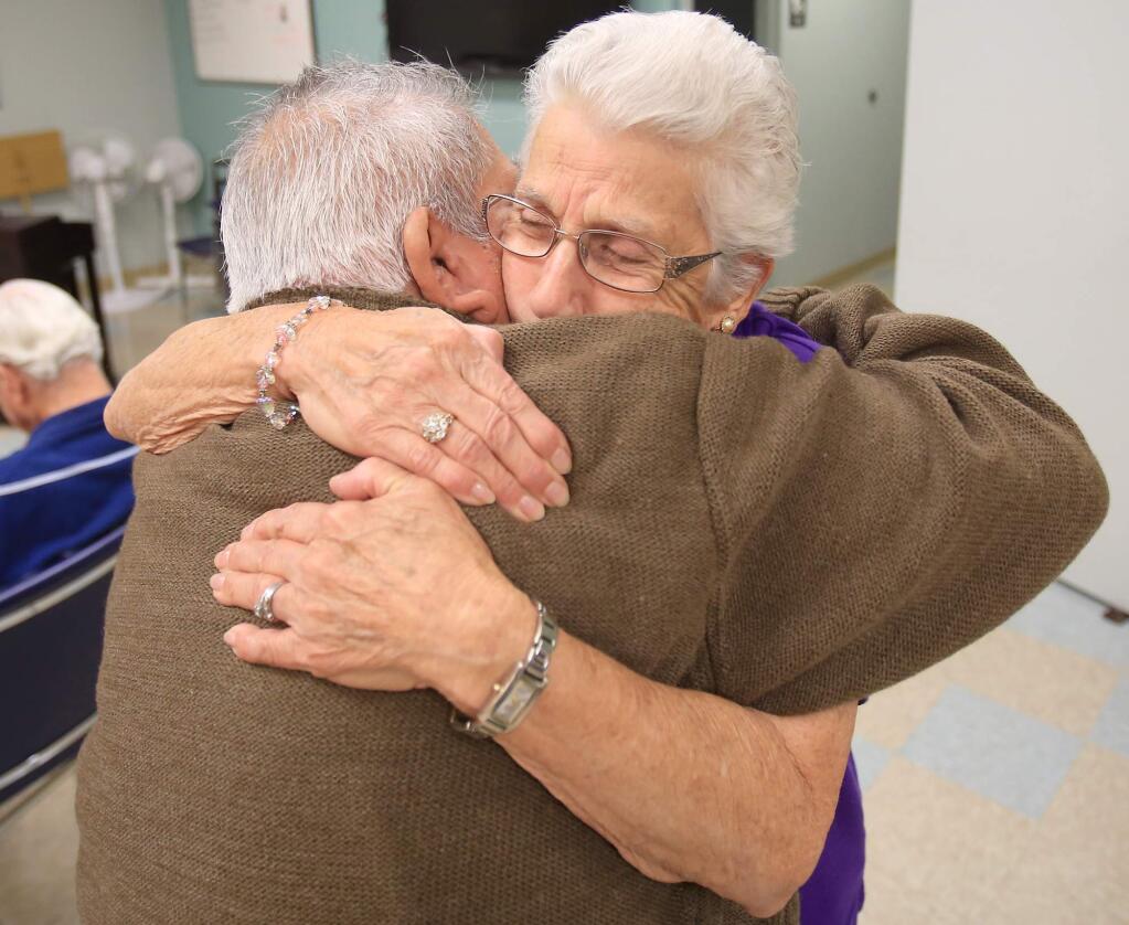 Terry Silva, right, greets Rudi Marin, Friday Nov. 6, 2015 at Catholic Charities in Santa Rosa. Silva has volunteered at Catholic Charities for more than 20 years. She volunteered with her husband until he became one of the Alzheimers patients himself. (Kent Porter / Press Democrat) 2015