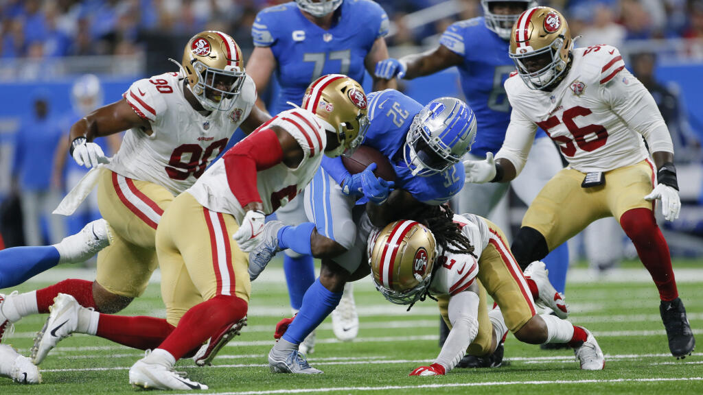Detroit Lions running back D'Andre Swift (32) runs as San Francisco 49ers defensive back Jason Verrett (2) makes the tackle in the first half of an NFL football game in Detroit, Sunday, Sept. 12, 2021. (AP Photo/Duane Burleson)