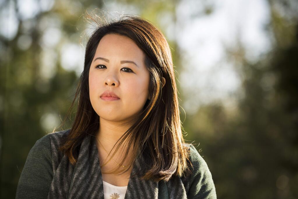 In this Feb. 25, 2015, photo, Ebola survivor Nina Pham poses for a photo in Dallas. Pham told The Dallas Morning News in the interview that she is preparing to file a lawsuit Monday, March 2, in Dallas County against Texas Health Resources. She said she continues to suffer from body aches and insomnia after contracting the disease from a patient she cared for last fall at Texas Health Presbyterian Hospital Dallas. (AP Photo/The Dallas Morning News, Smiley N. Pool) MANDATORY CREDIT; MAGS OUT; TV OUT; INTERNET USE BY AP MEMBERS ONLY; NO SALES