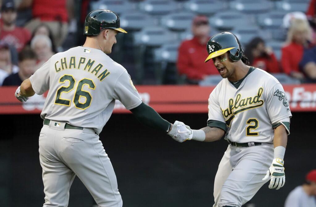 The Oakland Athletics' Khris Davis, right, celebrates his two-run home run with Matt Chapman during the first inning against the Los Angeles Angels on Saturday, Sept. 29, 2018, in Anaheim. (AP Photo/Marcio Jose Sanchez)