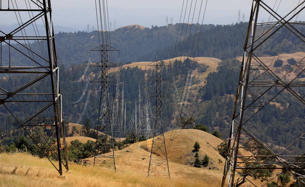 Power lines drop down from the the Mayacamas Mountains near The Geysers area into Knights Valley on Pine Flat Road on Tuesday, Aug. 6, 2019. (KENT PORTER/ PD)