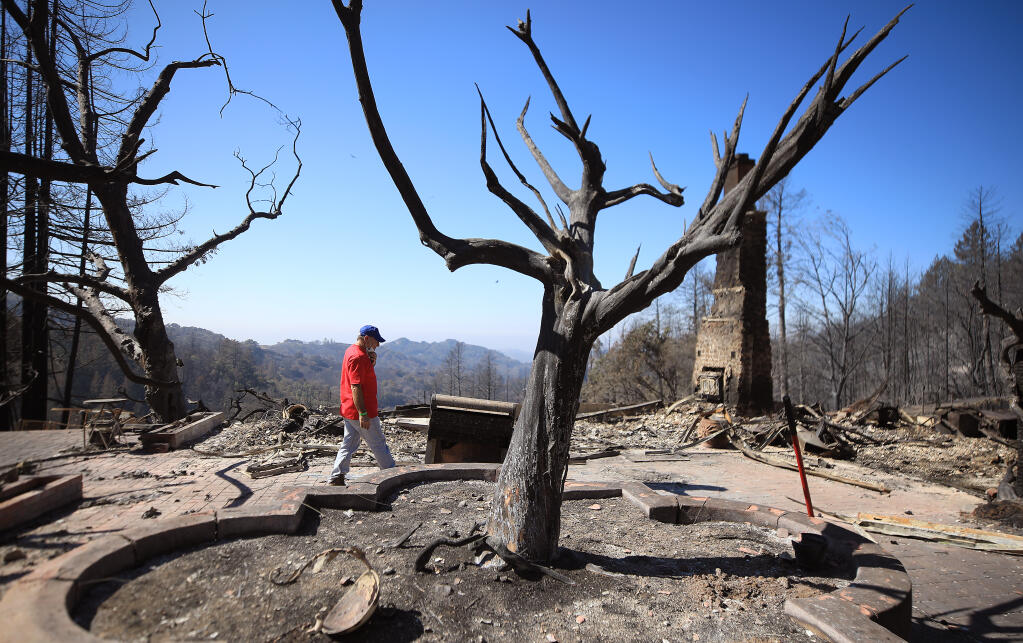 Dan Sanchez contemplates the ruins of his home, Wednesday, Oct. 7, 2020, after the Glass fire torched the dwelling on Holst Lane off Los Alamos Road near Santa Rosa last week. (Kent Porter / The Press Democrat) 2020
