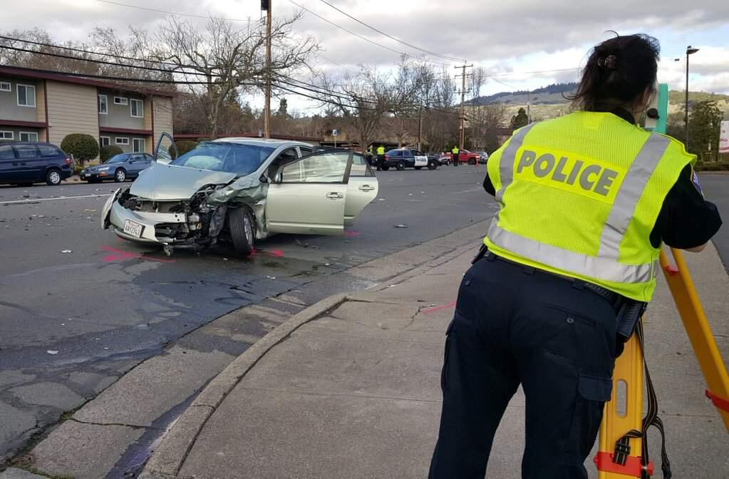 Santa Rosa police investigate the scene of a two-car crash on Montecito Boulevard in Rincon Valley, Sunday, Jan. 10, 2016. (DEREK MOORE/ PD)