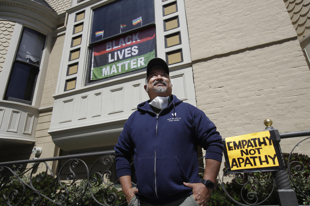 FILE - In this June 14, 2020, file photo, James Juanillo poses outside of his home in San Francisco. (AP Photo/Jeff Chiu, File)
