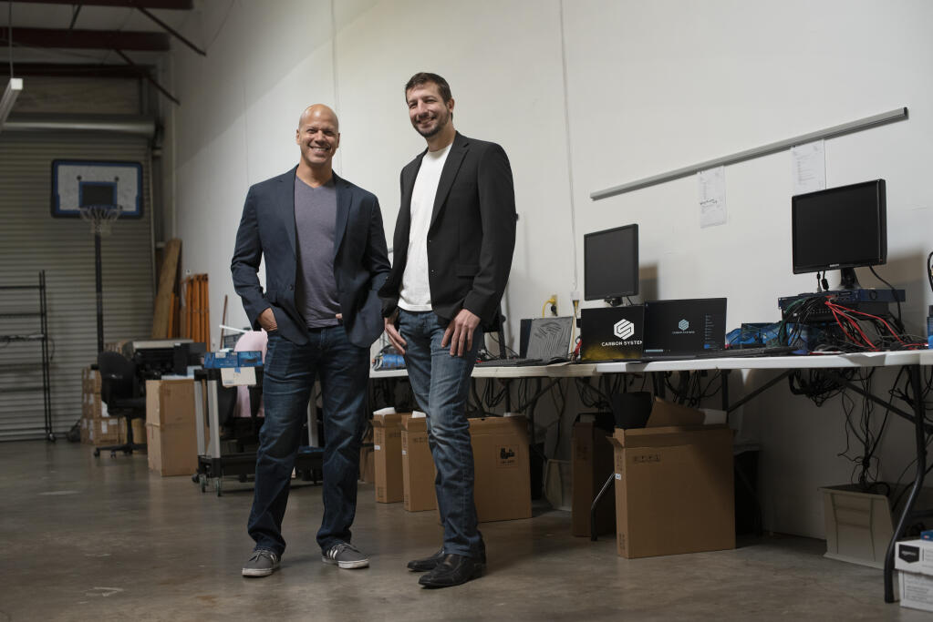 Carbon Systems COO John Rosebaugh, left, and CEO David Cook at the Carbon Systems production warehouse in Santa Rosa on Thursday, March 11, 2021. (Erik Castro / For The Press Democrat)