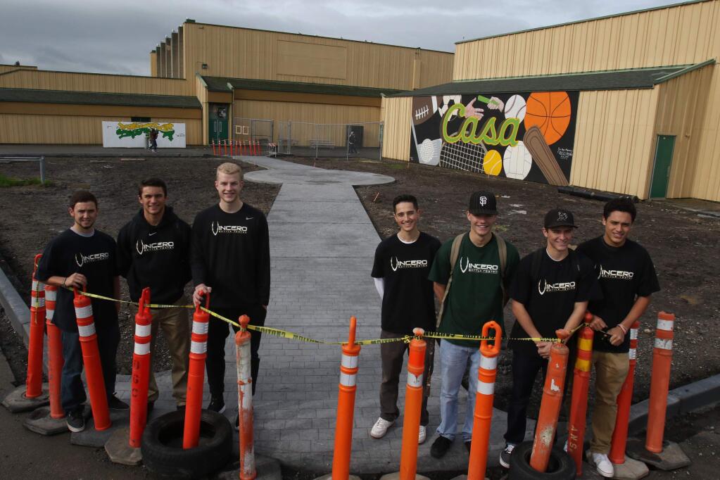 Casa Grande High School seniors who are spearheading the project to build a walkway in honor of James Forni in front of the school gym are left to right, Stephen Proctor, Nic Petri, JJ Anderson, Shane Ghiringhelli, Dylan Roberts, Jimmy Burggraf, and Kaleo Garrigan at the site of the project on Monday, March 14, 2016. Not pictured is Connor Hanley. (SCOTT MANCHESTER/ARGUS-COURIER STAFF)