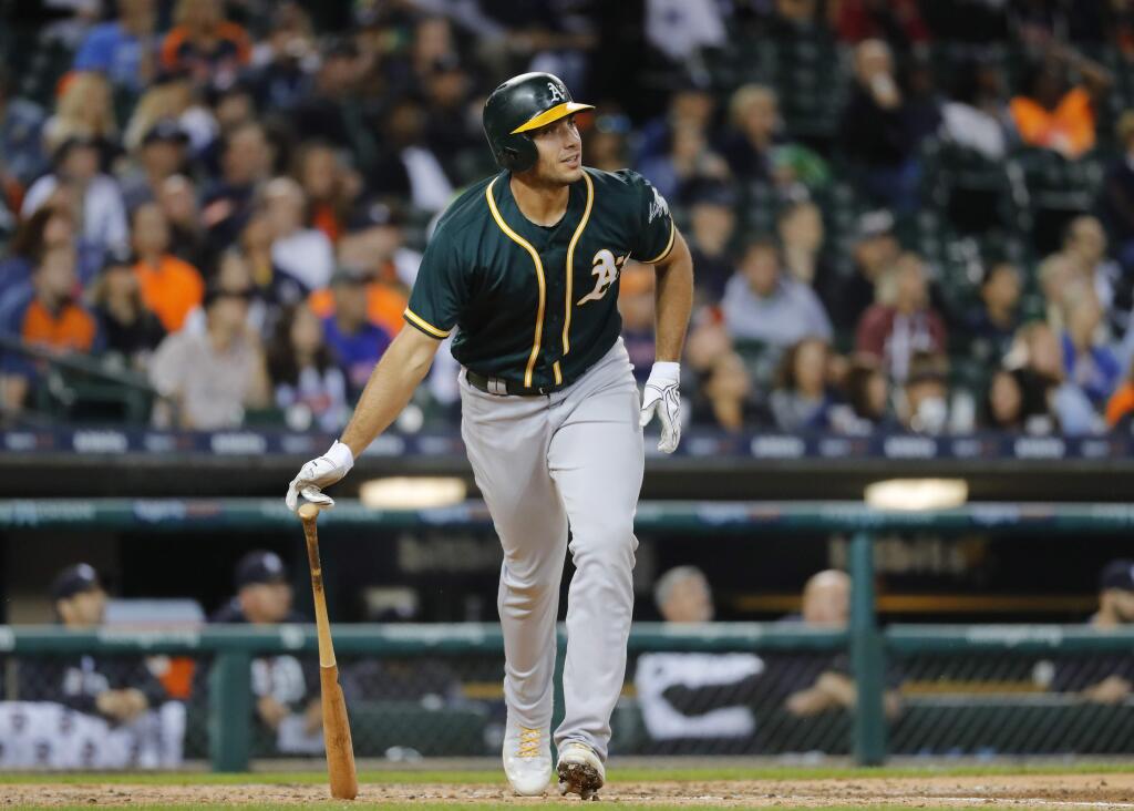 Oakland Athletics' Matt Olson watches his solo home run against the Detroit Tigers in the third inning of a baseball game in Detroit, Monday, Sept. 18, 2017. (AP Photo/Paul Sancya)