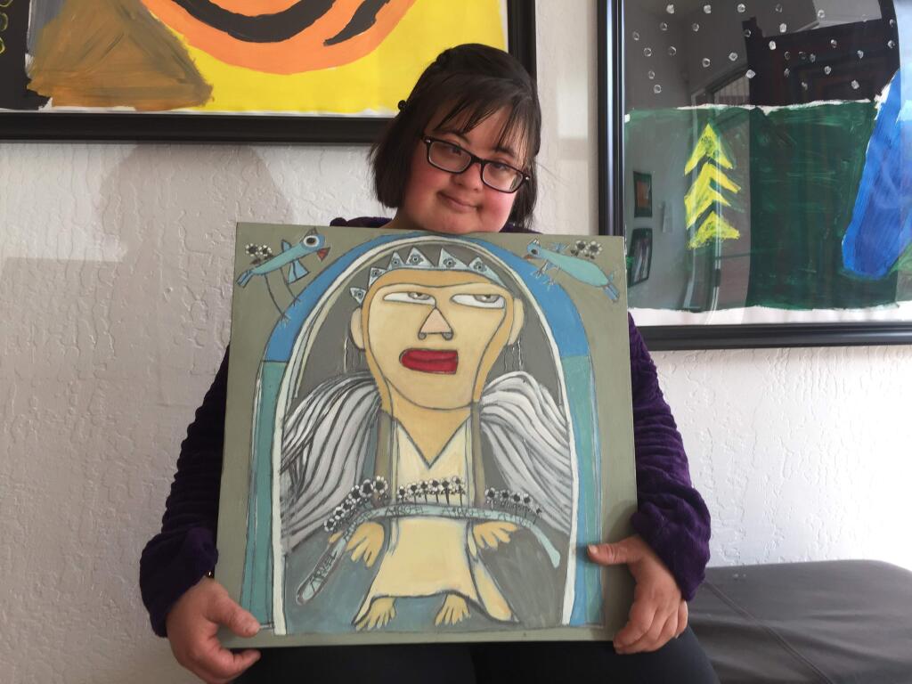Nora Chavez, artist, with one of her paintings