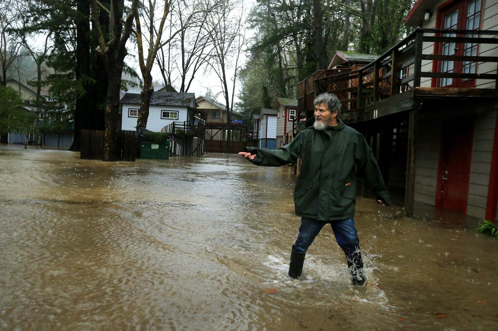 Rick Ramirez returns from moving his family out of their flooded apartment on Church Street in Guerneville early Sunday morning, Jan. 8, 2017. (John Burgess/The Press Democrat) (John Burgess/The Press Democrat)