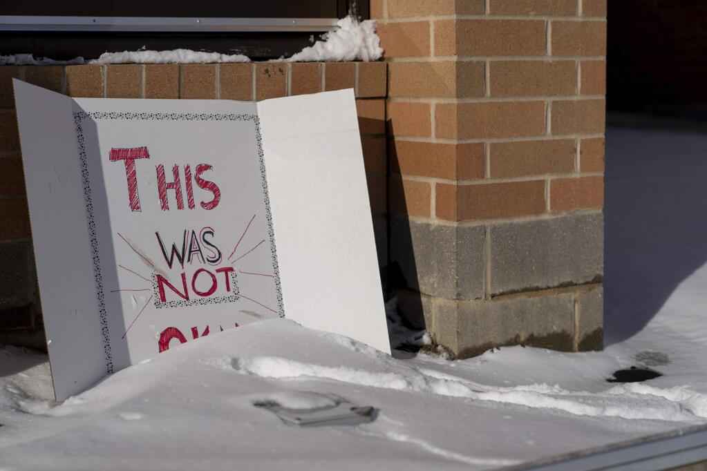 A sign reading 'This was not okay,' is seen in front of Covington Catholic High School in Park Kills, Ky., Sunday, Jan 20, 2019. A diocese in Kentucky has apologized after videos emerged showing students from the Catholic boys' high school mocking Native Americans outside the Lincoln Memorial on Friday after a rally in Washington. (AP Photo/Bryan Woolston)