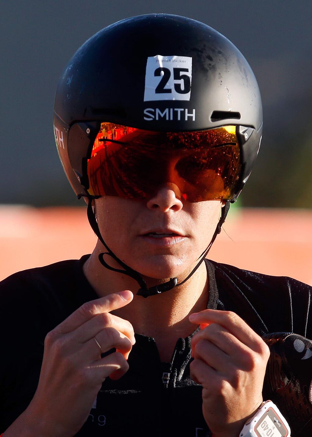Triathlete Chealsea Tiner fastens her helmet before embarking on the 112-mile cycle stage during Ironman Santa Rosa at Lake Sonoma, near Geyserville, California, on Saturday, July 29, 2017. (Alvin Jornada / The Press Democrat)