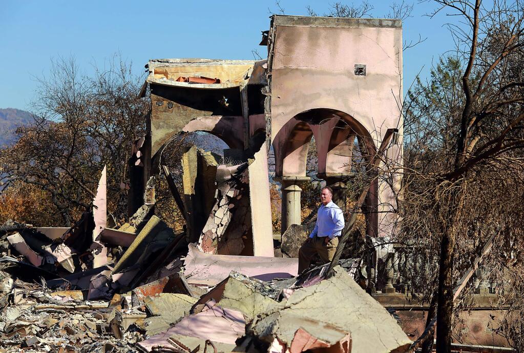 Tony Astone, an independent public adjuster who represent the policyholder, not the insurance companies, stands amidst the remains of a clients home in Kenwood. (photo by John Burgess/The Press Democrat)