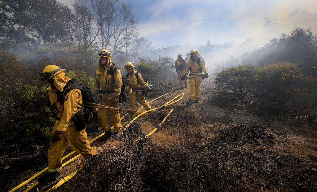 A Cal Fire crew makes it to the right flank (east) of the Sharp fire near Calistoga, Tuesday, August 20, 2019. (Kent Porter / The Press Democrat) 2019