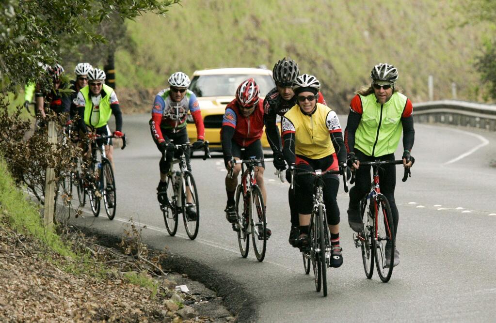 A group of cyclists head up Calistoga Road during a century bike ride in 2013. Among the benefits of a century ride are exercise, fresh air and comraderie.