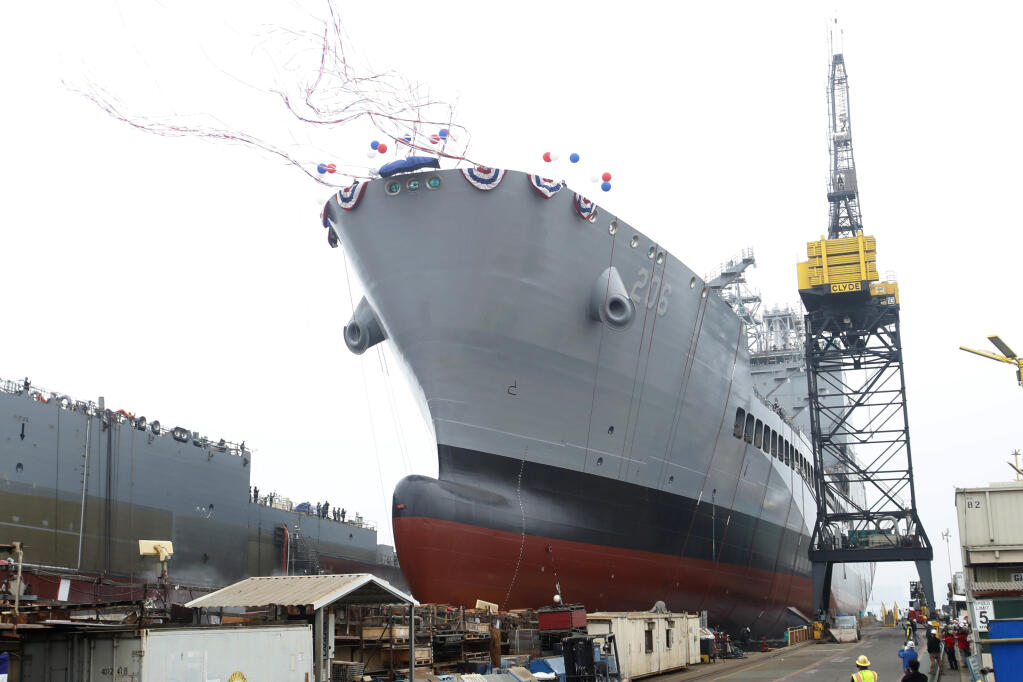 The U.S. Navy launches the USNS Harvey Milk, a fleet replenishment oiler ship named after the first openly gay elected official, in San Diego, Saturday, Nov. 6, 2021. The Navy ship is the second of six vessels in the Navy's John Lewis-class program, second to the USNS John Lewis. (AP Photo/Alex Gallardo)