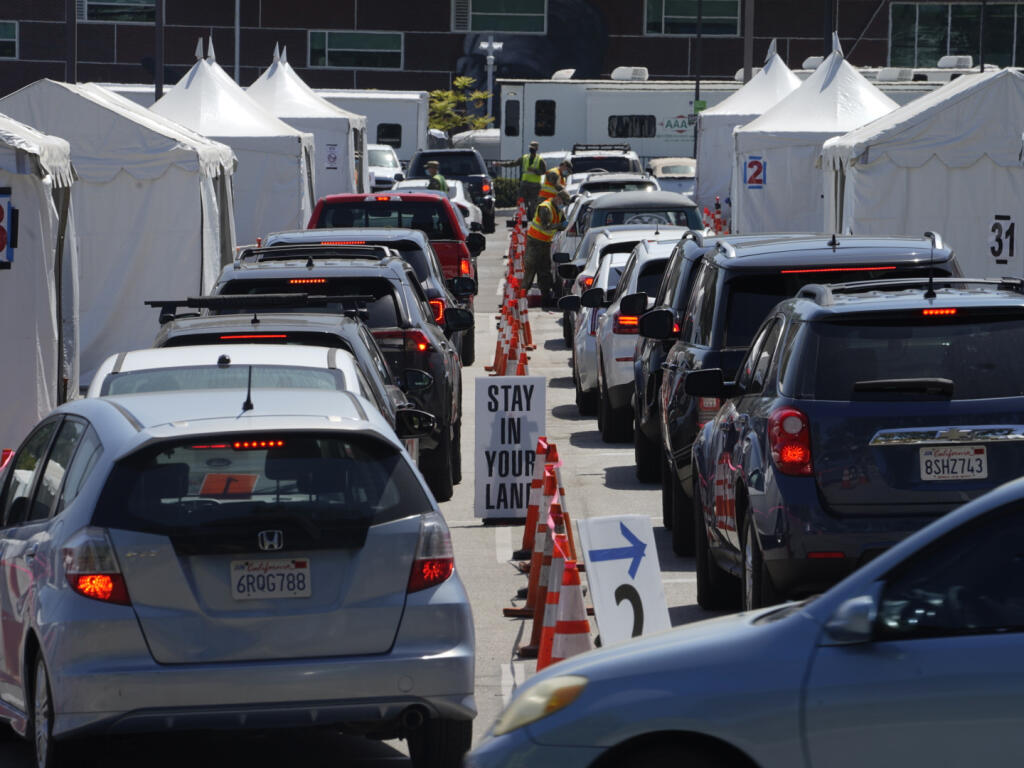 In this April 8, 2021 file photo motorists sit inside their vehicles as they wait their turn to be inoculated with a COVID-19 vaccine at the California State University, Los Angeles campus in Los Angeles. (AP Photo/Damian Dovarganes)