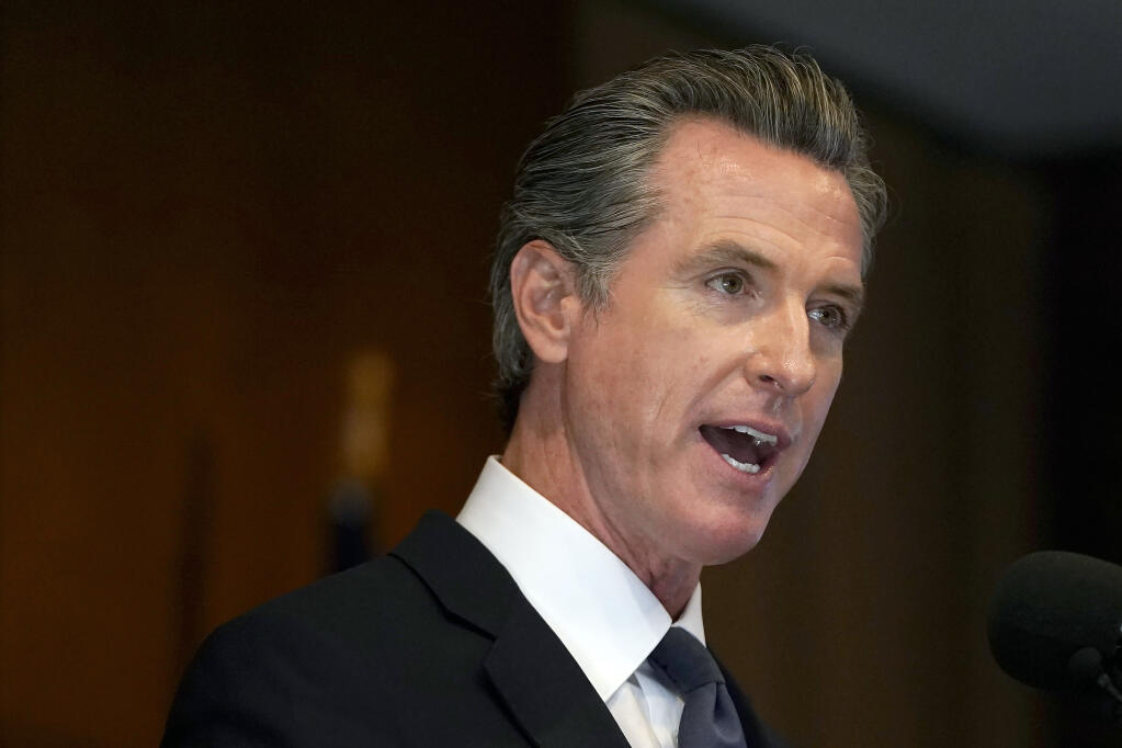 FILE - In this Sept. 14, 2021, file photo, California Gov. Gavin Newsom speaks in San Francisco. On Friday, Sept. 24, 2021, Newsom signed a law replacing the word "alien" in state law when referring to noncitizens. Newsom said the term is outdated and derogatory. The word will be replaced with words like "noncitizen" and "immigrant." U.S. President Joe Biden ordered federal immigration agencies to stop using the word "alien" earlier this year. (AP Photo/Jeff Chiu, File)