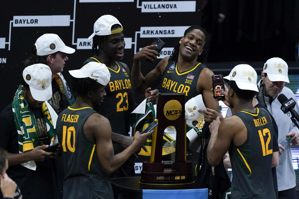Baylor players celebrate with the trophy at the end of the championship game against Gonzaga in the men's Final Four NCAA college basketball tournament, Monday, April 5, 2021, at Lucas Oil Stadium in Indianapolis. Baylor won 86-70. (AP Photo/Michael Conroy)