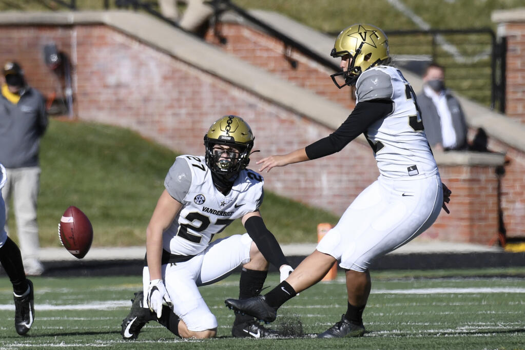 Vanderbilt’s Sarah Fuller, right, kicks off as Ryan McCord holds to start the second half against Missouri Saturday, Nov. 28, 2020, in Columbia, Missouri. With the kick, Fuller became the first woman to play in a Power Five conference game. (L.G. Patterson / ASSOCIATED PRESS)