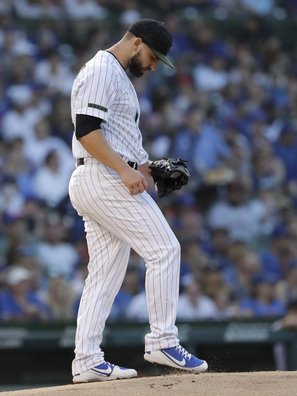 Chicago Cubs starting pitcher Tyler Chatwood kicks the mound during the first inning of a baseball game against the San Francisco Giants in Chicago, Sunday, May 27, 2018. (AP Photo/Nam Y. Huh)