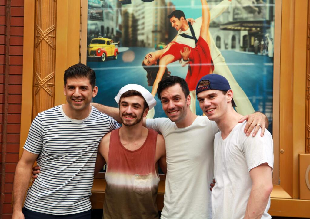 Ricky Ubeda, second from left, poses with Tony Yazbeck, left, Clyde Alves, second from right, and Jay Armstrong Johnson, the three stars of the Broadway musical ìOn the Townî outside the Lyric Theatre in New York on Sept. 5, 2104. Ubeda, 18, from Miami, won Season 11 of ìSo You Think You Can Danceî and one of the prizes was an ensemble role in the show. (AP Photo/Mark Kennedy)