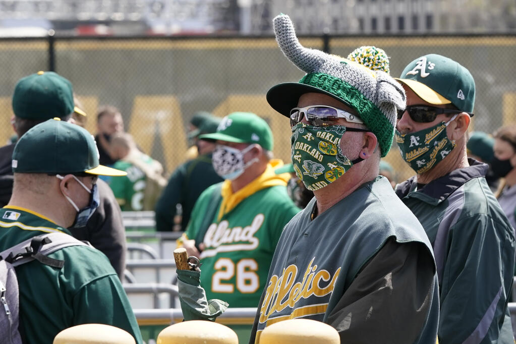 A’s fans wait to enter the Oakland Coliseum before a game against the Houston Astros on Saturday, April 3, 2021. (Jeff Chiu / ASSOCIATED PRESS)