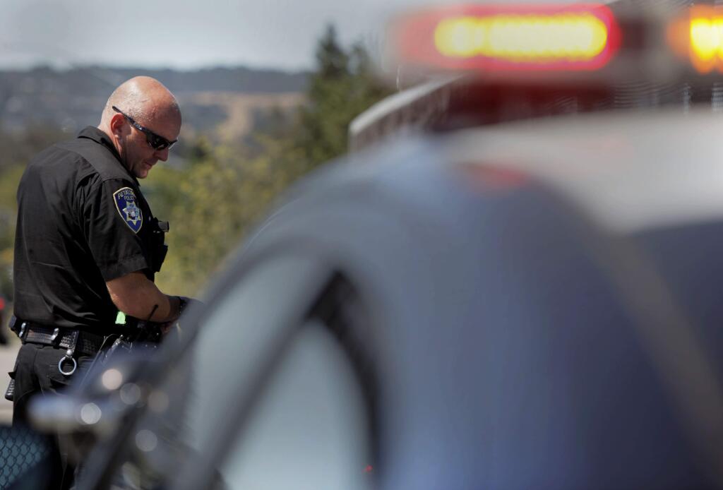 Petaluma, CA, USA.Thursday, July 28, 2016. Petaluma Police Officer Rob Hawkins pulls over a vehicle for a traffic violation on East Washington and issued a warning.(CRISSY PASCUAL/ARGUS-COURIER STAFF)