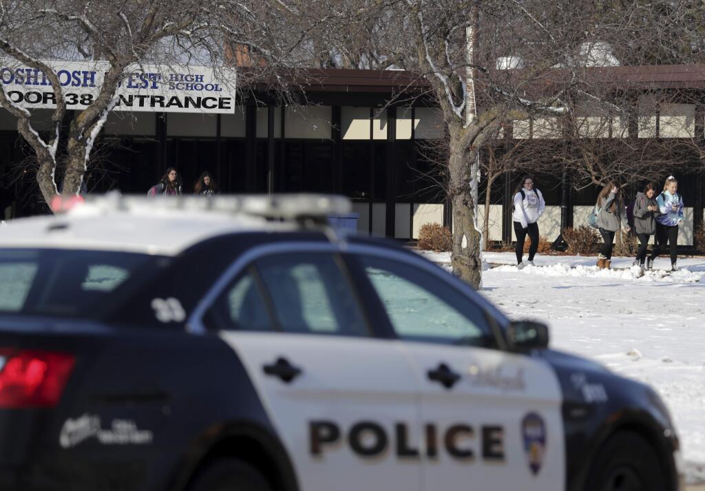 Students are evacuated from the scene of an officer involved shooting at Oshkosh West High School after an armed student confronted a school resource officer on Tuesday December 3, 2019, at in Oshkosh, Wis. Police in Oshkosh say a police officer and an armed student whom he confronted at the school were both wounded in the confrontation Tuesday morning. (Wm. Glasheen/The Post-Crescent via AP)