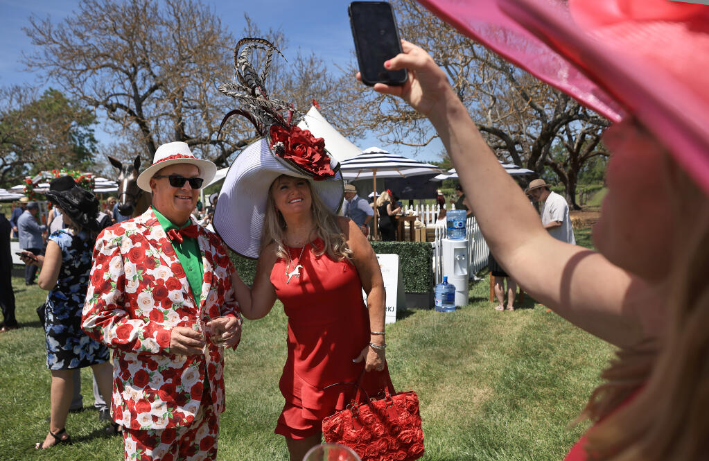 Shaun Takkinen and Randi Miller of Huntington Beach have their picture taken by Maggie Curry of Healdsburg at the Kentucky Derby party at Kendall-Jackson Wine Estate and Gardens in Santa Rosa on Saturday, May 7, 2022. (Kent Porter/The Press Democrat)
