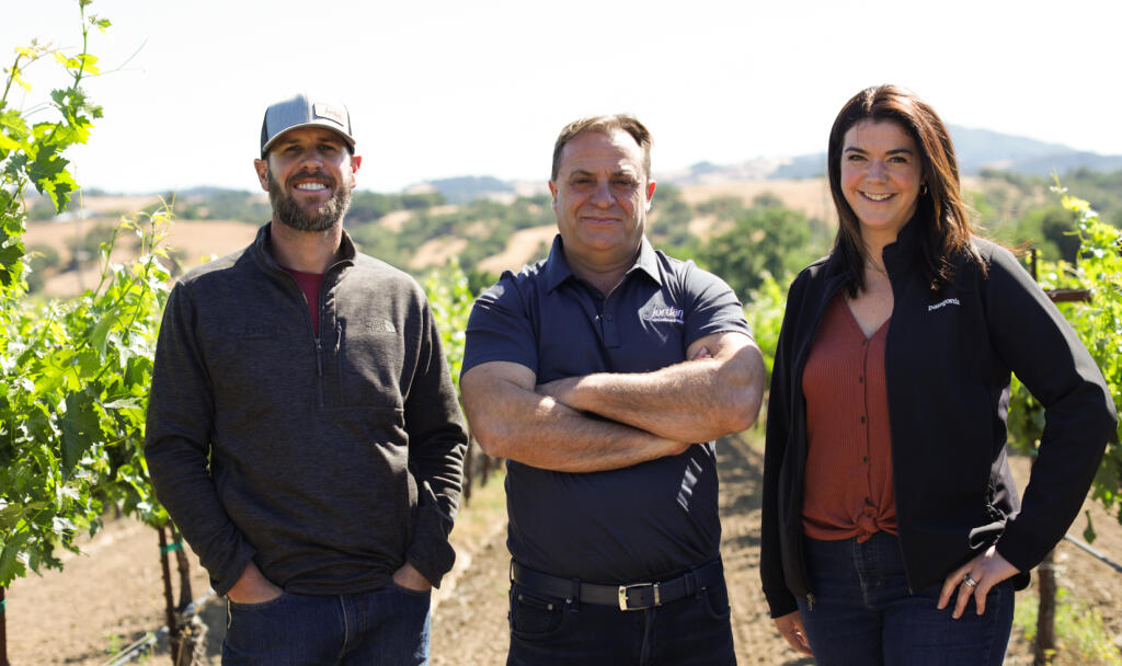 Brent Young, director of agricultural operations at Jordan Vineyard and Winery; owner John Jordan and winemaker Maggie Kruse pose outside Meola Vineyard in the Alexander Valley. (Jordan Vineyard and Winery)