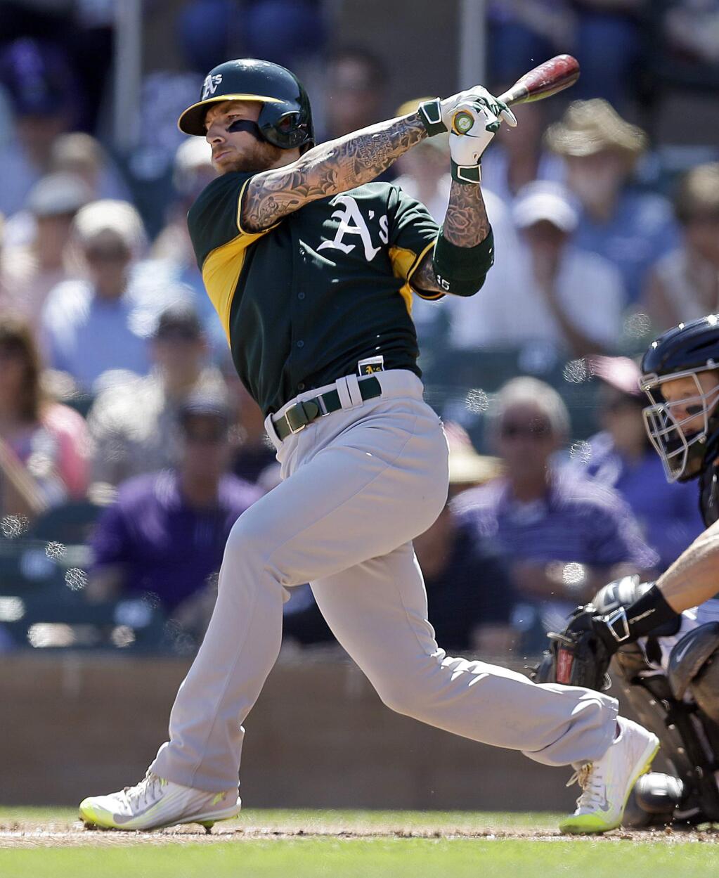 Oakland Athletics' Brett Lawrie fouls off a pitch against the Colorado Rockies in the first inning of a spring training exhibition baseball game Friday, March 20, 2015, in Scottsdale, Ariz. (AP Photo/Ben Margot)