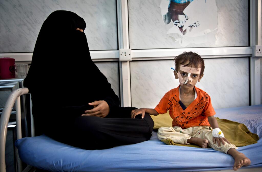 In an undated handout photo, a woman and Yemeni child in Sana'a, Yemen. Yemen, always an impoverished country, has been upended for two years by fighting between the Saudi-backed military coalition and Houthi rebels and their allies. (MARCO FRATTINI / World Food Program via The New York Times)