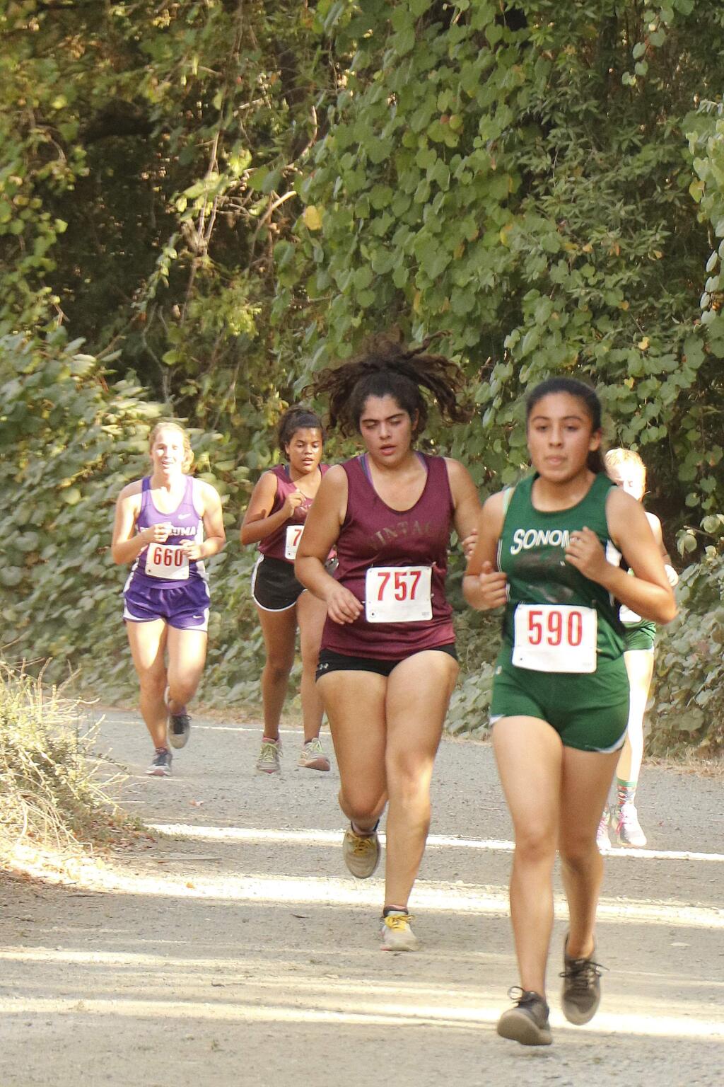 Sonoma Valley's JV girls runner Carmen Carrillo sets the pace for a cross-country peloton in the first Vine Valley race ever held, on Sept. 26 at Maxwell Farms Regional Park, Sonoma. (Christian Kallen / Index-Tribune)