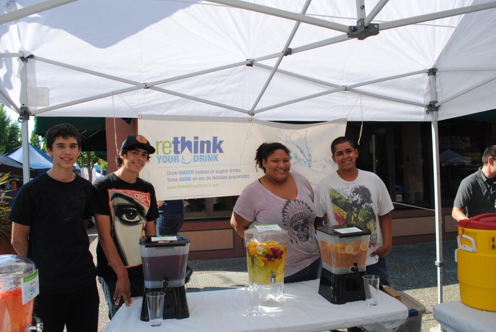 Participants in at a “rethink your drink” event offer alternatives to soft drinks in 2012. (Michele Anna Jordan)