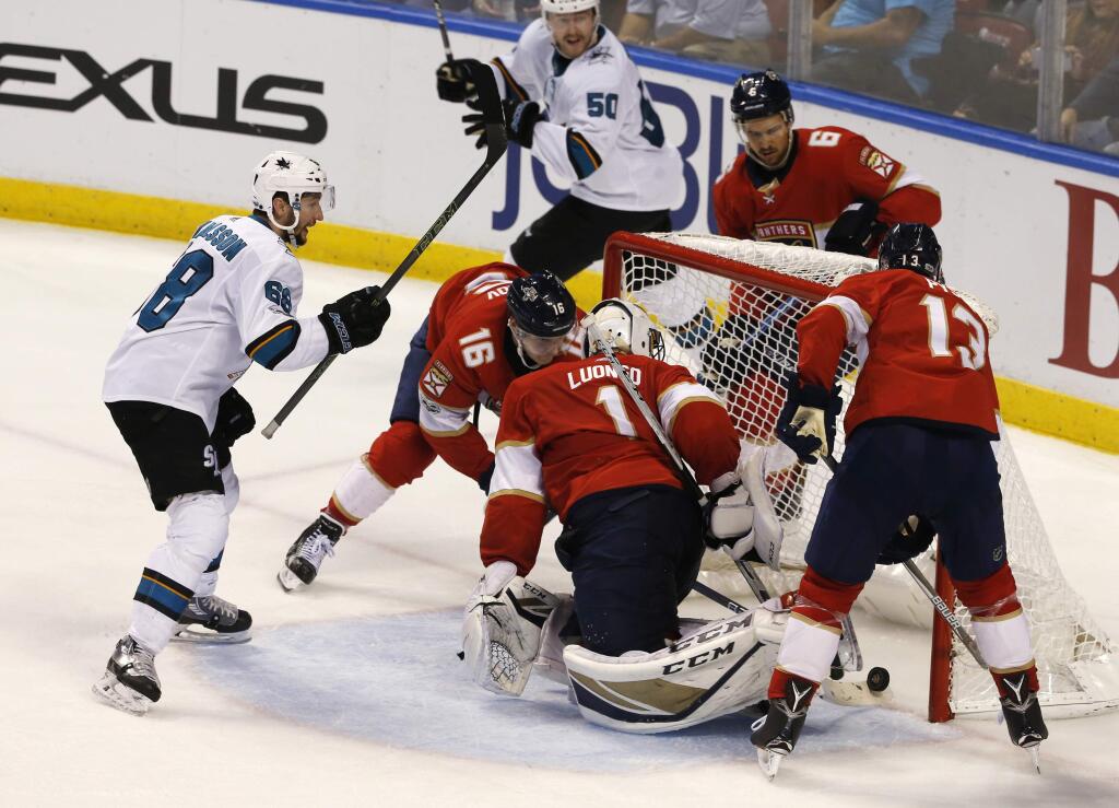 San Jose Sharks center Chris Tierney, rear, reacts to his third-period goal as Florida Panthers goalie Roberto Luongo can't make the save Friday, Dec. 1, 2017, in Sunrise, Florida. The Sharks won 2-1. (AP Photo/Joe Skipper)