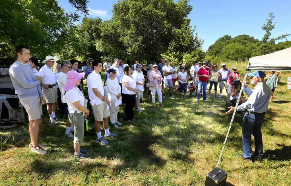 About 60 people gathered in a field off Chanate Rd. in Santa rosa to voice their opposition to the proposed housing on the 82 acre site with includes the old hospital complex. (John Burgess/The Press Democrat)