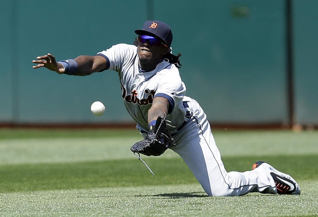 Detroit Tigers' Cameron Maybin cannot make the catch on a ball hit for a two-run single by Oakland Athletics' Billy Butler in the sixth inning of a baseball game Sunday, May 29, 2016, in Oakland, Calif. (AP Photo/Ben Margot)