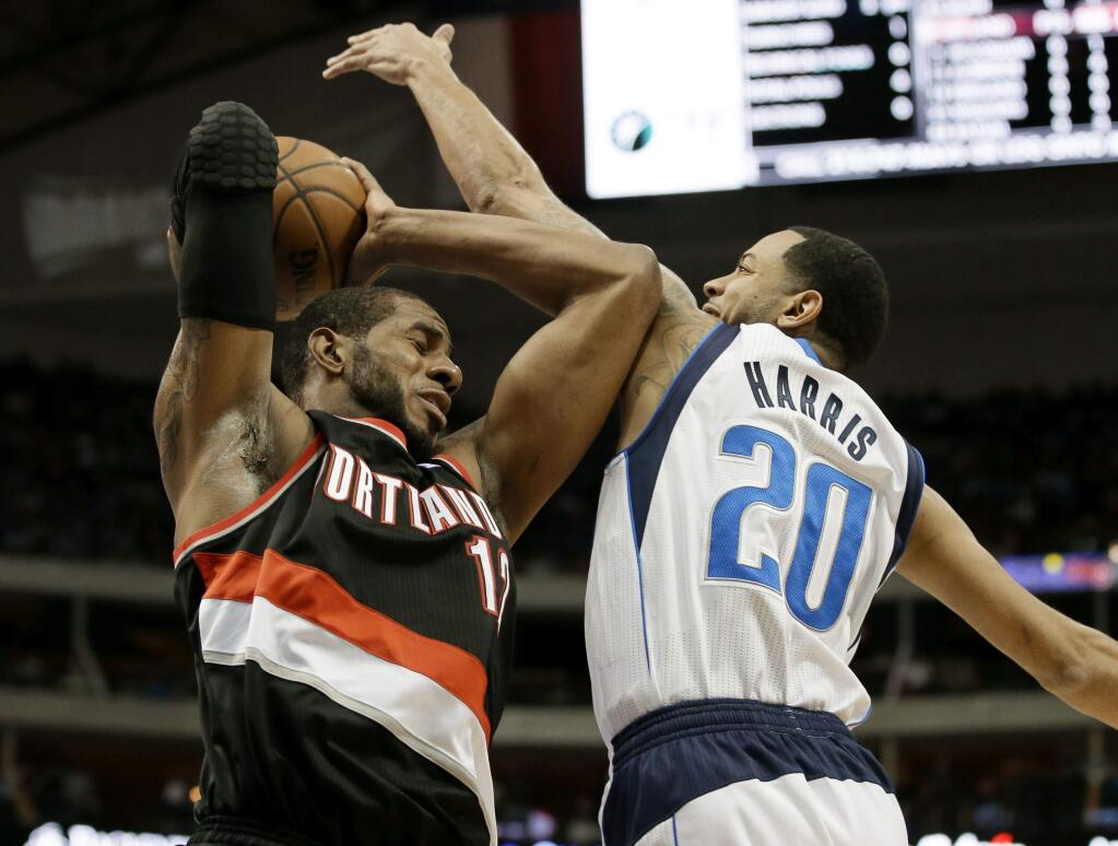 LaMarcus Aldridge, left, shown here exercising his will against Dallas forward Devin Harris, will be muscling up on the front line for the San Antonio Spurs next season. (Tony Gutierrez / Associated Press)