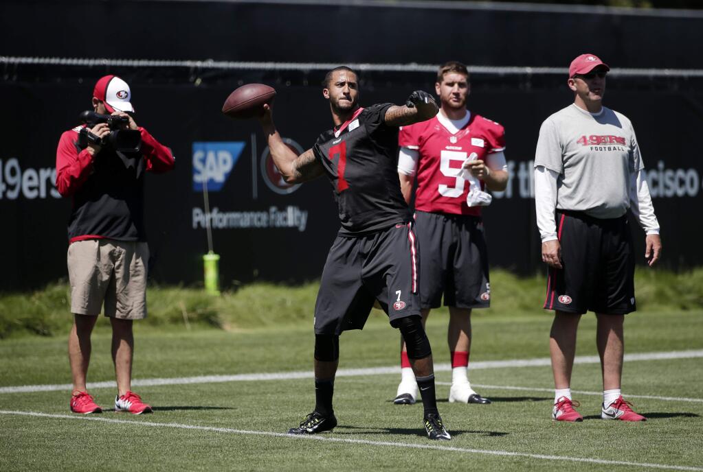 San Francisco 49ers quarterback Colin Kaepernick (7) is videotaped as he throws during an NFL football training camp on Friday, July 25, 2014, in Santa Clara. (AP Photo)