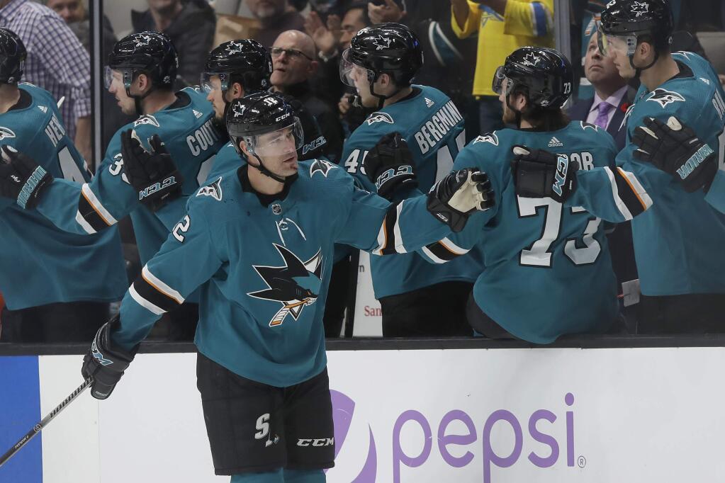 San Jose Sharks center Patrick Marleau, foreground, is congratulated by teammates after he scored against the Chicago Blackhawks during the second period in San Jose, Tuesday, Nov. 5, 2019. (AP Photo/Jeff Chiu)