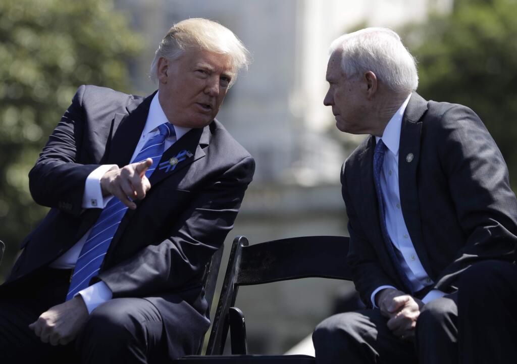 FILE - In this May 15, 2017, file photo, President Donald Trump talks with Attorney General Jeff Sessions,at the 36th Annual National Peace Officers' memorial service on Capitol Hill in Washington. Sessions did not disclose contacts with foreign dignitaries, including the Russian ambassador, on a security clearance form he filled out as a United States senator last year, the Justice Department acknowledged May 24. The department said Sessions' staff relied on the guidance of the FBI investigator handling the background check, who advised that meetings with foreign dignitaries “connected with Senate activities” did not have to be reported on the form. (AP Photo/Evan Vucci, file)