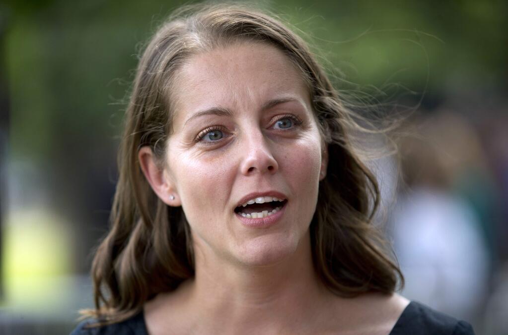 In this photo taken June 26, 2014, Rebekah Erler speaks to members of the media at Minnehaha Park in Minneapolis, Minn. Erler is a guest to watch President Barack Obama's State of the Union address on Capitol Hill Tuesday. (AP Photo/Pablo Martinez Monsivais)