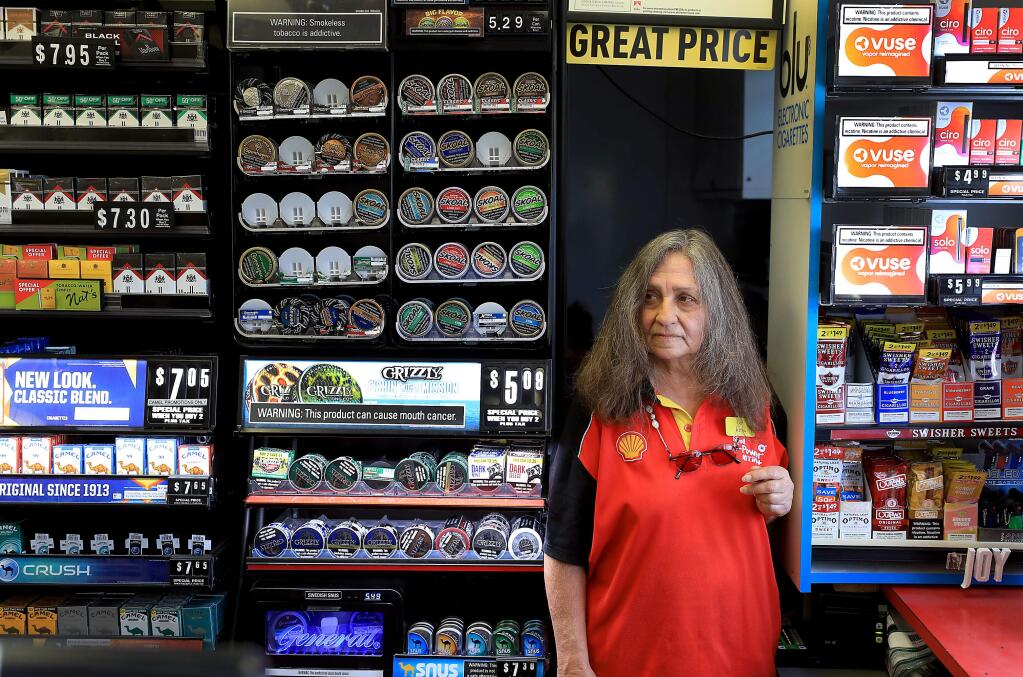 Rotha Rice of Rohnert Park pauses during her cashier's job at a Shell gas station in Cotati/Rohnert Park, Wednesday, July 18, 2018. Rotha was given a 90-day evection notice to vacate her apartment in Rohnert Park, in close proximity to her job. Since the October fires, Section 8 housing is becoming more difficult to find. Rotha is fearful she won't be able to find a place that accepts Section 8 vouchers and would be forced to quit her job of 26 years at the station. (Kent Porter / The Press Democrat) 2018