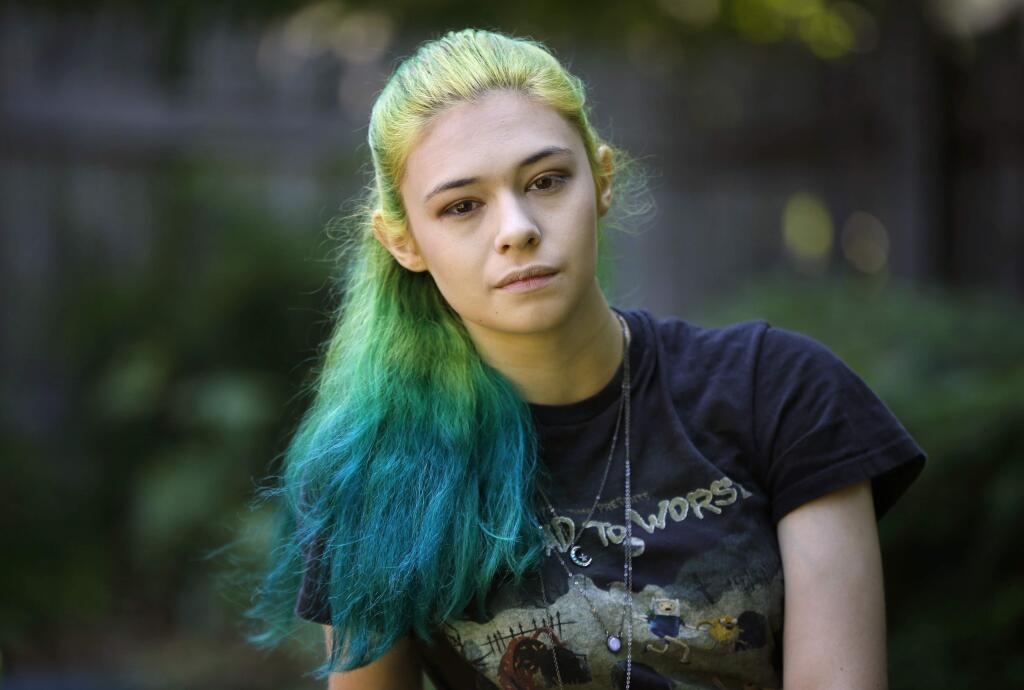 In this Sunday, June 26, 2016 photo Nicole Maines poses at her home in Portland, Maine. Maines, a transgender activist who won a discrimination lawsuit after her school refused to let her use the girls' bathroom will be TV's first transgender superhero. Maines will star in The CW/Warner Bros.' 'Supergirl' as Nia Nal, aka Dreamer. Producers describe her character as a 'soulful young transgender woman with a fierce drive to protect others.' (AP Photo/Robert F. Bukaty)